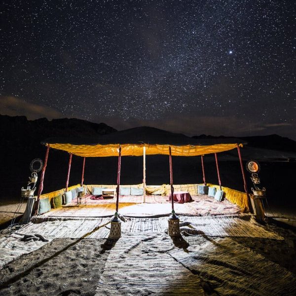 Private desert camping tent under starry sky
